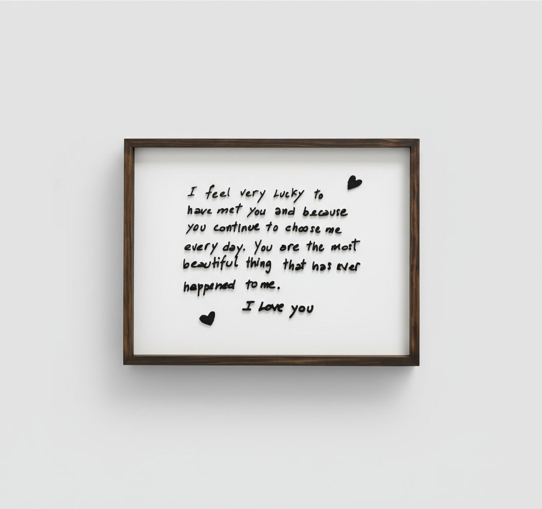 Framed print with a romantic message on a white wall