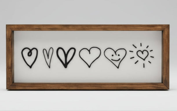 Wooden frame with black heart designs on a white background