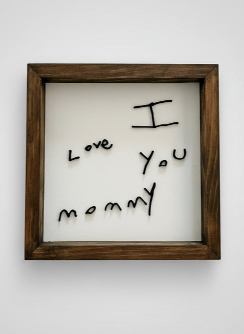 Framed picture with 'I love you mommy' text on a white background