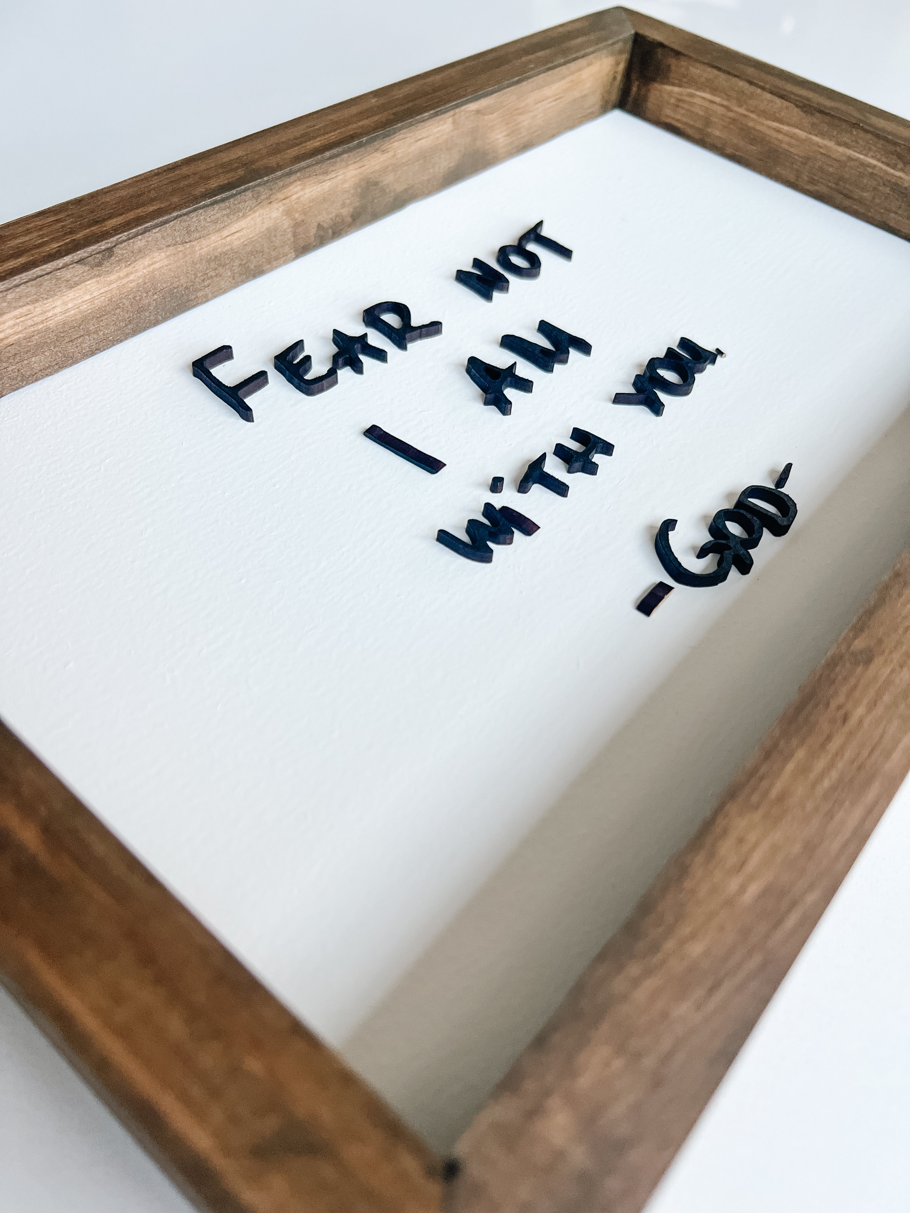 Framed wooden plaque with engraved message 'FEAR NOT I AM WITH YOU GOD' on a white background