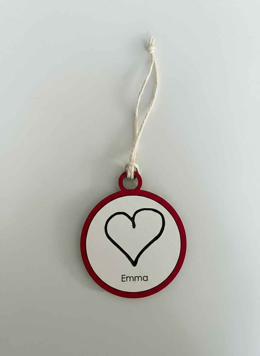 Heart-shaped tag with 'Emma' on a white background